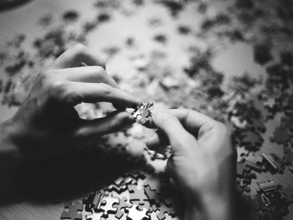 grayscale photo of person holding flower